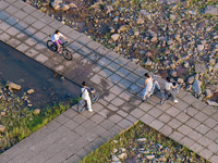 Citizens are playing on the beach of the Jialing River as the water level drops in Chongqing, China, on May 26, 2024. (