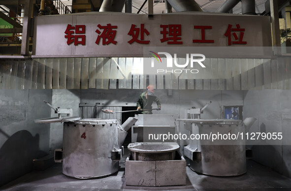 A worker is producing a wheel hub at a workshop of an automobile wheel manufacturer in Binzhou, China, on May 27, 2024. 