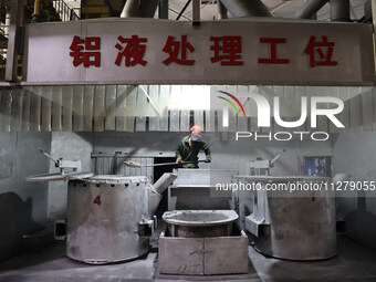 A worker is producing a wheel hub at a workshop of an automobile wheel manufacturer in Binzhou, China, on May 27, 2024. (