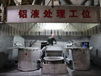 A worker is producing a wheel hub at a workshop of an automobile wheel manufacturer in Binzhou, China, on May 27, 2024. (