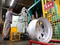 A worker is producing a wheel hub at a workshop of an automobile wheel manufacturer in Binzhou, China, on May 27, 2024. (