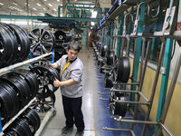 A worker is producing a wheel hub at a workshop of an automobile wheel manufacturer in Binzhou, China, on May 27, 2024. (