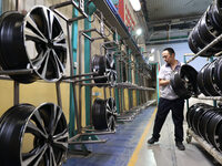 A worker is producing a wheel hub at a workshop of an automobile wheel manufacturer in Binzhou, China, on May 27, 2024. (