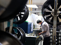 A worker is producing a wheel hub at a workshop of an automobile wheel manufacturer in Binzhou, China, on May 27, 2024. (