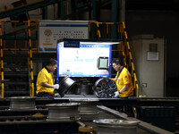 Workers are producing wheels at a workshop of an automobile wheel manufacturer in Binzhou, China, on May 27, 2024. (