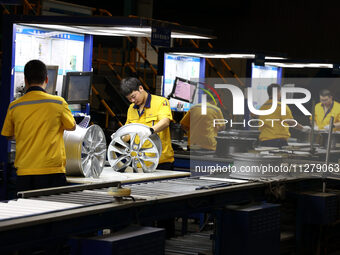 Workers are producing wheels at a workshop of an automobile wheel manufacturer in Binzhou, China, on May 27, 2024. (