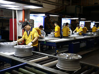 Workers are producing wheels at a workshop of an automobile wheel manufacturer in Binzhou, China, on May 27, 2024. (