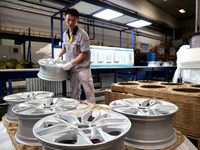 A worker is producing a wheel hub at a workshop of an automobile wheel manufacturer in Binzhou, China, on May 27, 2024. (