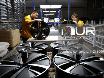 Workers are producing wheels at a workshop of an automobile wheel manufacturer in Binzhou, China, on May 27, 2024. (