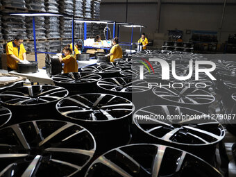 Workers are producing wheels at a workshop of an automobile wheel manufacturer in Binzhou, China, on May 27, 2024. (