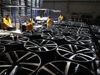 Workers are producing wheels at a workshop of an automobile wheel manufacturer in Binzhou, China, on May 27, 2024. (