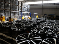 Workers are producing wheels at a workshop of an automobile wheel manufacturer in Binzhou, China, on May 27, 2024. (