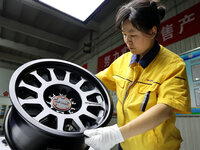 A worker is producing a wheel hub at a workshop of an automobile wheel manufacturer in Binzhou, China, on May 27, 2024. (