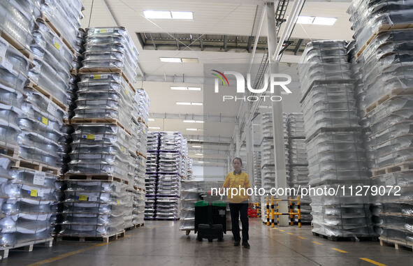 A worker is producing a wheel hub at a workshop of an automobile wheel manufacturer in Binzhou, China, on May 27, 2024. 