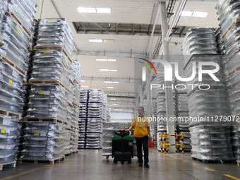 A worker is producing a wheel hub at a workshop of an automobile wheel manufacturer in Binzhou, China, on May 27, 2024. (