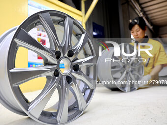 A worker is producing a wheel hub at a workshop of an automobile wheel manufacturer in Binzhou, China, on May 27, 2024. (