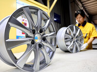 A worker is producing a wheel hub at a workshop of an automobile wheel manufacturer in Binzhou, China, on May 27, 2024. (