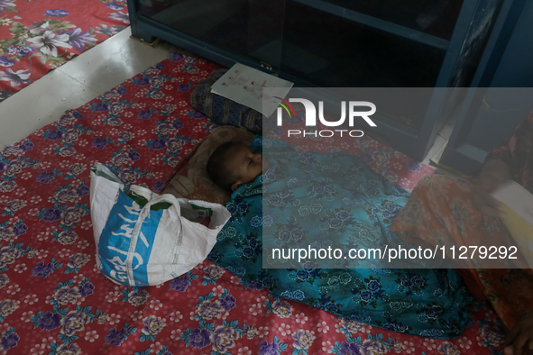 An infant baby is being seen in a cyclone shelter center as Cyclone Remal is landing in Satkhura, Bangladesh, on May 27, 2024. 