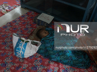 An infant baby is being seen in a cyclone shelter center as Cyclone Remal is landing in Satkhura, Bangladesh, on May 27, 2024. (