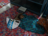 An infant baby is being seen in a cyclone shelter center as Cyclone Remal is landing in Satkhura, Bangladesh, on May 27, 2024. (