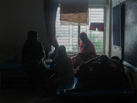 People are taking shelter in a school as Cyclone Remal is landing in Satkhira, Bangladesh, on May 27, 2024 (