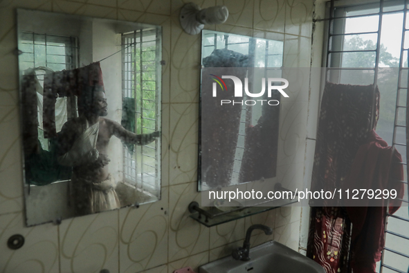 A man is taking shelter in a school as Cyclone Remal is landing in Satkhira, Bangladesh, on May 27, 2024 