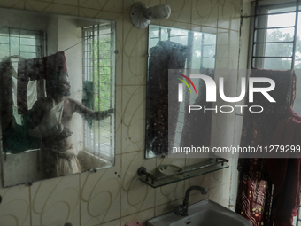 A man is taking shelter in a school as Cyclone Remal is landing in Satkhira, Bangladesh, on May 27, 2024 (