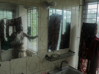 A man is taking shelter in a school as Cyclone Remal is landing in Satkhira, Bangladesh, on May 27, 2024 (