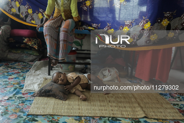 An infant baby is being seen in a cyclone shelter center as Cyclone Remal is landing in Satkhura, Bangladesh, on May 27, 2024. 