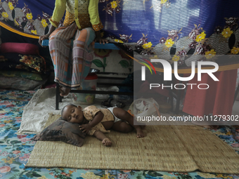 An infant baby is being seen in a cyclone shelter center as Cyclone Remal is landing in Satkhura, Bangladesh, on May 27, 2024. (