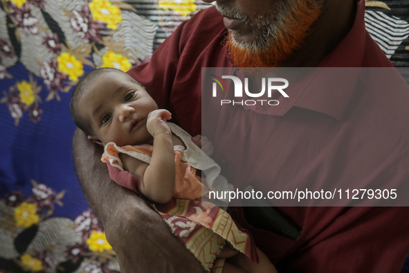 An infant baby is being seen in a cyclone shelter center as Cyclone Remal is landing in Satkhura, Bangladesh, on May 27, 2024. 