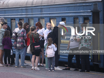 Families with children are evacuating from the frontline areas of Kharkiv region on the train as they go on vacation to western Ukraine with...