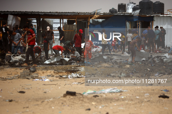 Palestinians are gathering at the site of an Israeli strike on a camp for internally displaced people in Rafah, on May 27, 2024, amid ongoin...