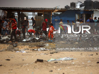 Palestinians are gathering at the site of an Israeli strike on a camp for internally displaced people in Rafah, on May 27, 2024, amid ongoin...