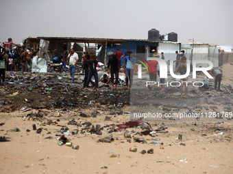 Palestinians are gathering at the site of an Israeli strike on a camp for internally displaced people in Rafah, on May 27, 2024, amid ongoin...