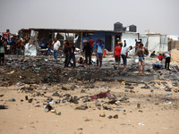 Palestinians are gathering at the site of an Israeli strike on a camp for internally displaced people in Rafah, on May 27, 2024, amid ongoin...