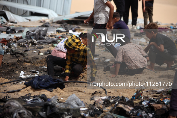 Palestinians are gathering at the site of an Israeli strike on a camp for internally displaced people in Rafah, on May 27, 2024, amid ongoin...