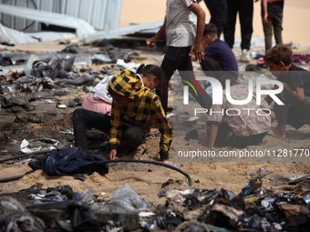 Palestinians are gathering at the site of an Israeli strike on a camp for internally displaced people in Rafah, on May 27, 2024, amid ongoin...