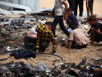 Palestinians are gathering at the site of an Israeli strike on a camp for internally displaced people in Rafah, on May 27, 2024, amid ongoin...