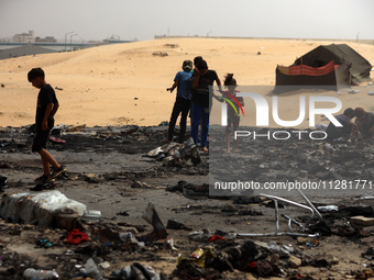 Palestinians are gathering at the site of an Israeli strike on a camp for internally displaced people in Rafah, on May 27, 2024, amid ongoin...