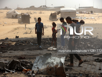 Palestinians are gathering at the site of an Israeli strike on a camp for internally displaced people in Rafah, on May 27, 2024, amid ongoin...