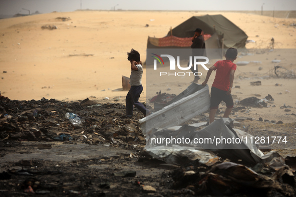 Palestinians are gathering at the site of an Israeli strike on a camp for internally displaced people in Rafah, on May 27, 2024, amid ongoin...