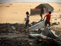 Palestinians are gathering at the site of an Israeli strike on a camp for internally displaced people in Rafah, on May 27, 2024, amid ongoin...