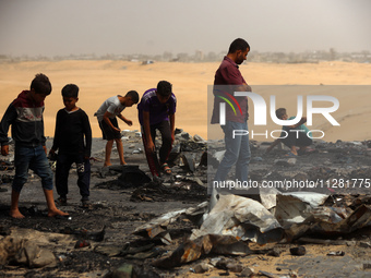 Palestinians are gathering at the site of an Israeli strike on a camp for internally displaced people in Rafah, on May 27, 2024, amid ongoin...