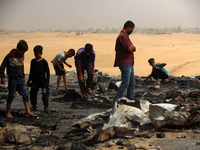 Palestinians are gathering at the site of an Israeli strike on a camp for internally displaced people in Rafah, on May 27, 2024, amid ongoin...