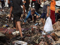 Palestinians are gathering at the site of an Israeli strike on a camp for internally displaced people in Rafah, on May 27, 2024, amid ongoin...