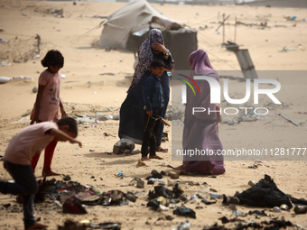 Palestinians are gathering at the site of an Israeli strike on a camp for internally displaced people in Rafah, on May 27, 2024, amid ongoin...