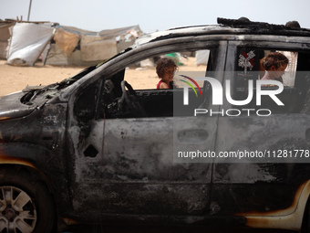 Palestinians are gathering at the site of an Israeli strike on a camp for internally displaced people in Rafah, on May 27, 2024, amid ongoin...