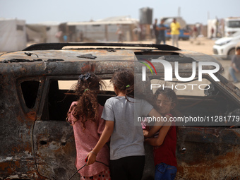 Palestinians are gathering at the site of an Israeli strike on a camp for internally displaced people in Rafah, on May 27, 2024, amid ongoin...