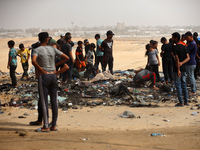 Palestinians are gathering at the site of an Israeli strike on a camp for internally displaced people in Rafah, on May 27, 2024, amid ongoin...